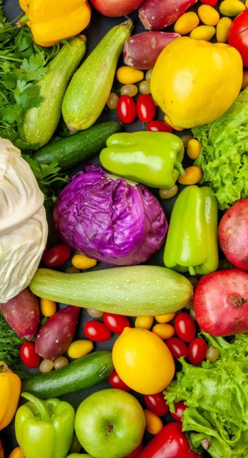 top-view-vegetables-fruits-zucchini-bell-peppers-apples-quince-cherry-tomatoes-cumcuat-parsley-cabbage-lemon-pomegranates