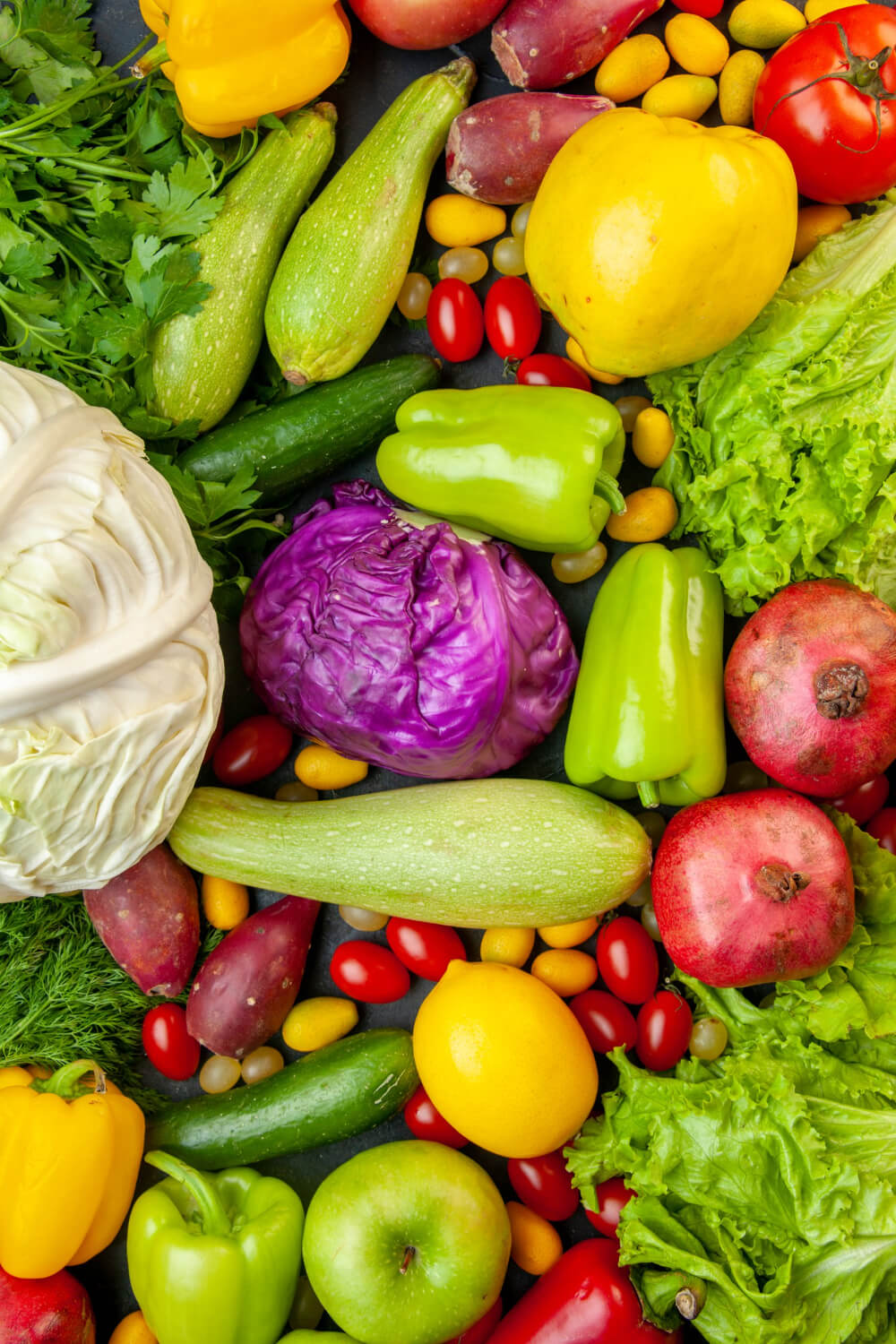 top-view-vegetables-fruits-zucchini-bell-peppers-apples-quince-cherry-tomatoes-cumcuat-parsley-cabbage-lemon-pomegranates